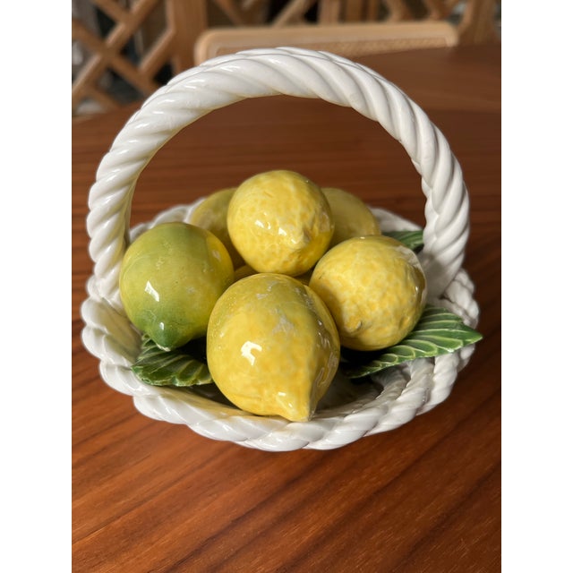 A sweet little Italian basket filled with glazed lemons in a bed of leaves. A perfect pop of color for your tablescape or...