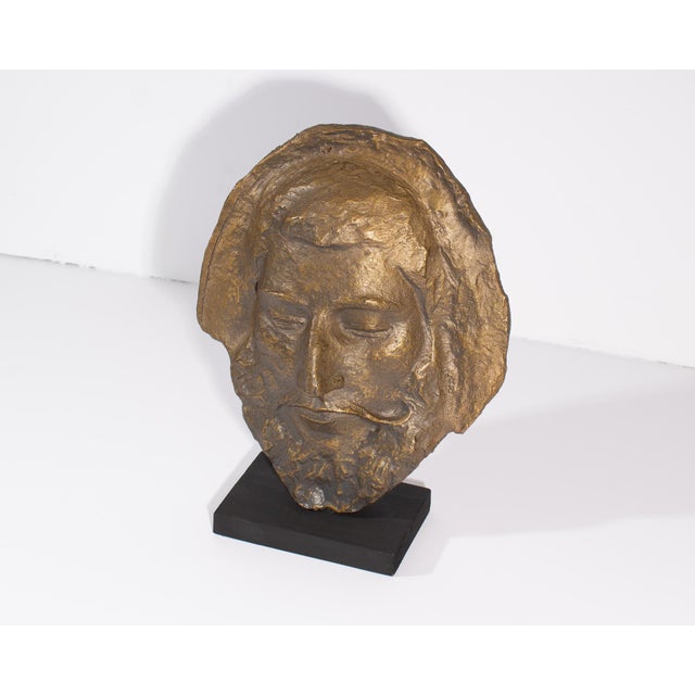 A bronze tone resin sculpture after a work by Paul Gaugin purportedly of a death mask of Aristotle. The sculpture is...