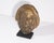 A bronze tone resin sculpture after a work by Paul Gaugin purportedly of a death mask of Aristotle. The sculpture is...