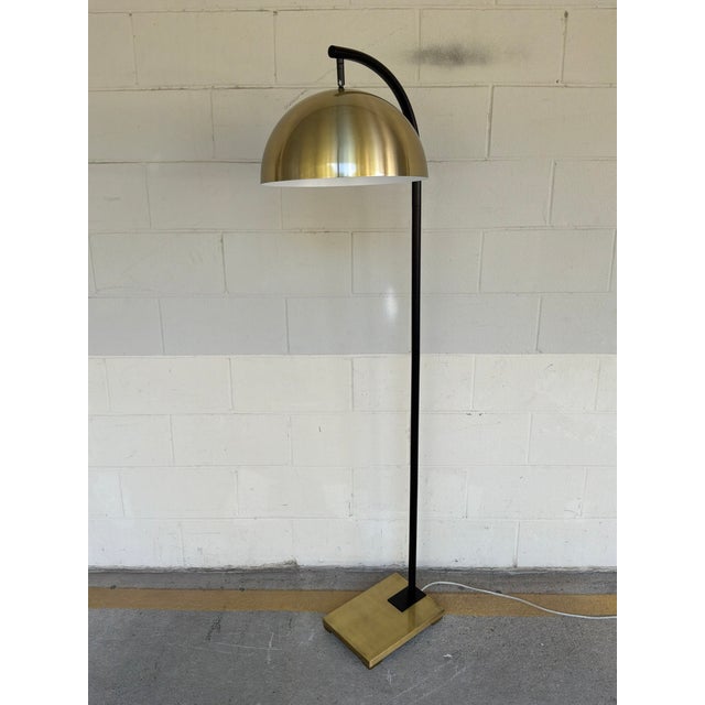 Stylish Black & Brass Floor lamp. Brass metal shade and brass rectangular base, black body. Showroom floor sample.
