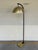 Stylish Black & Brass Floor lamp. Brass metal shade and brass rectangular base, black body. Showroom floor sample.