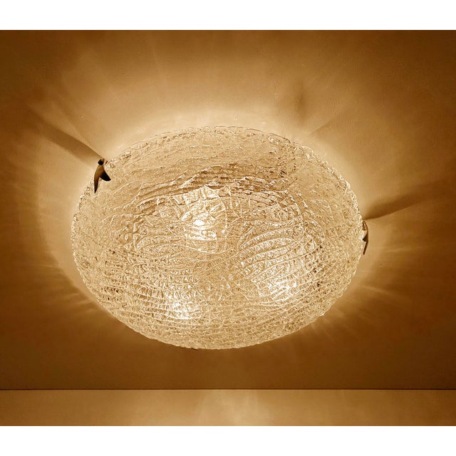 Large vintage brutalist glass flush mount light with a structured glass mounted on a silver enameled base and chromed...