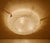 Large vintage brutalist glass flush mount light with a structured glass mounted on a silver enameled base and chromed...