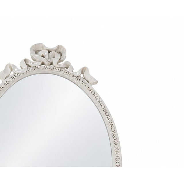 This exquisite French wall mirror features a classic oval silhouette, meticulously handcrafted and adorned with a delicate...