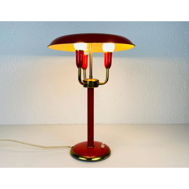 An Italian table lamp made in the 1960s. Made of metal and brass. The lighting has an exceptional design with 3 arms. The...