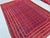 This vivid Andkhoy rug features a fine diamond trellis alternating between rich crimson and deep indigo compartments,...