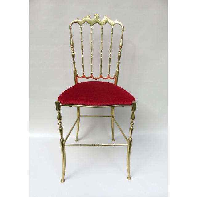 A chair ""Chiavari" from the 60s from Italy. The frame is brass, the seat is covered with red velvet. A delicate and...