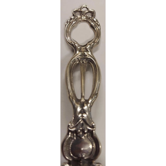 The spoon is marked sterling. It measures 10 1/2" long and weighs 7 Oz. It is in great original antique condition.