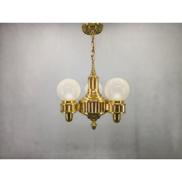 Beautiful Art Deco chandelier produced in Czechoslovakia during the 1930s. This elegant ceiling light features polished...