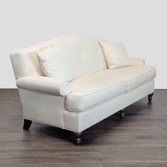 This elegant 3-seat sofa by Thomasville features a soft cream fabric, rolled arms, and a gently curved back. It includes...