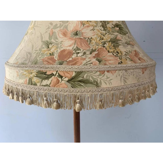 1960’s vintage standard lamp / floor lamp in solid turned teak. Matching large shade with tasseled fringing. Full working...