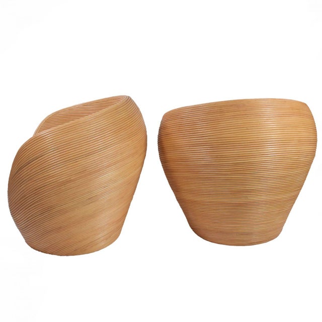 A dreamy pair of handmade pencil reed pod chairs — cocooning rattan shells with plush cushions that invite long, lazy...