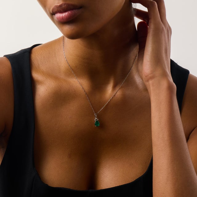 This elegant vintage necklace centers on a beautifully shaped pear cut emerald weighing approximately 1.60 carats,...