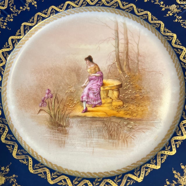 Truly an amazing find! Intricately handpainted Limoges cabinet plate in a background with a cobalt band encrusted with a...