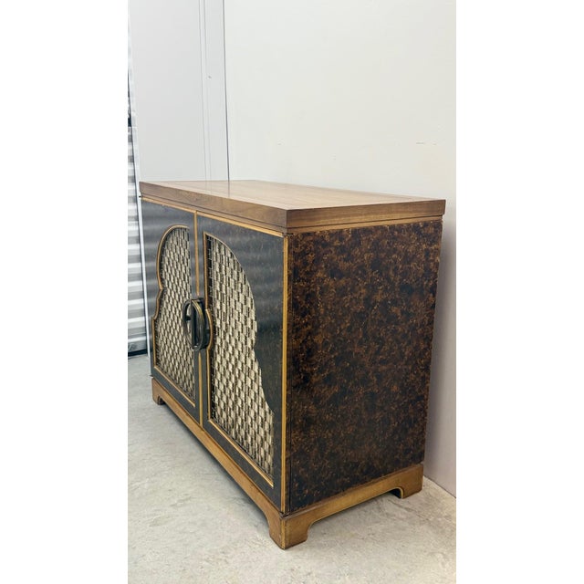 Mid-Century John Widdicomb Lacquered Moorish Cabinet A striking mid-century cabinet by John Widdicomb, featuring the...