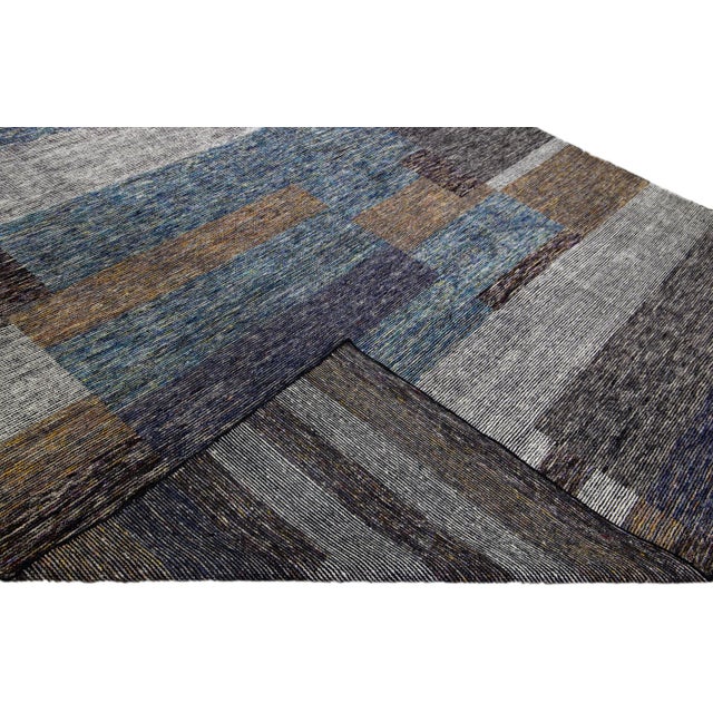 Beautiful modern Apadana's Safi Collection hand-knotted wool rug with an earthy colors field. This Modern rug has blue,...