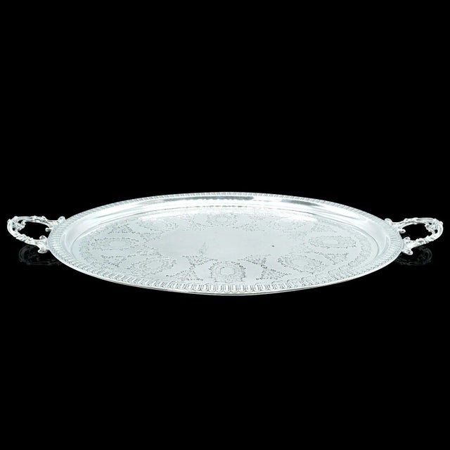 This is an antique oval decorative serving tray. An English, silver plate afternoon tea plater by Walker & Hall, dating to...
