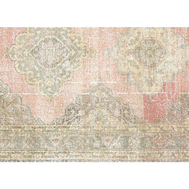 This Vintage Turkish Oushak Rug, handwoven with wool on a wool foundation in Western Turkey’s Oushak region, measures 4'6"...