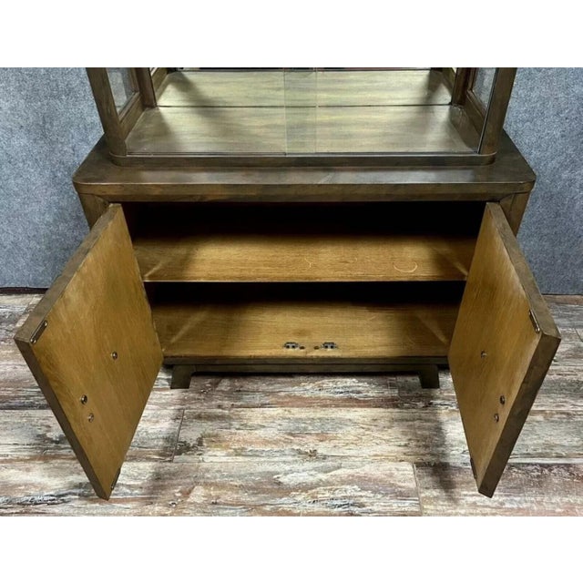 Art Deco period bookcase in lacquered wood with a decoration imitating rusted, patinated sheet metal, circa 1930-1940....