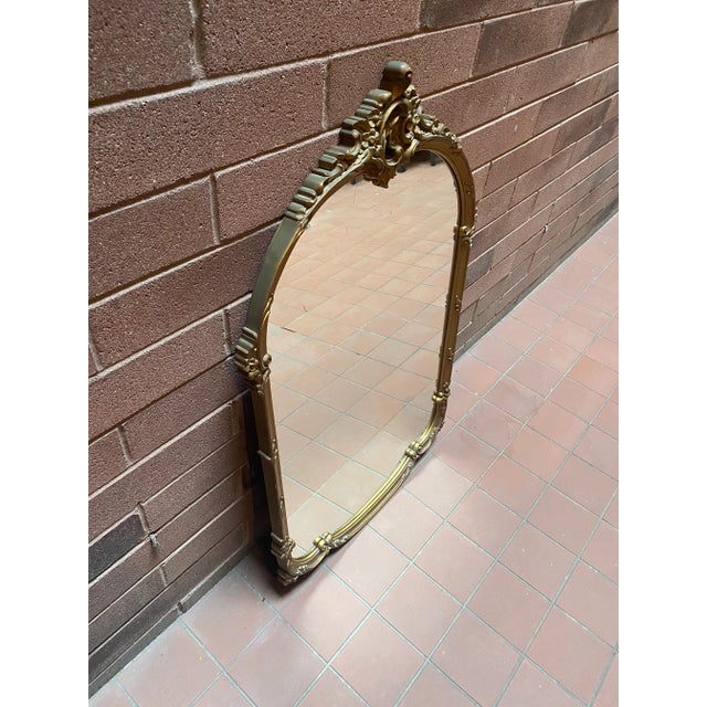 Beautiful vintage ornate gilt arched mirror. Ready to hang and stands at 42” tall