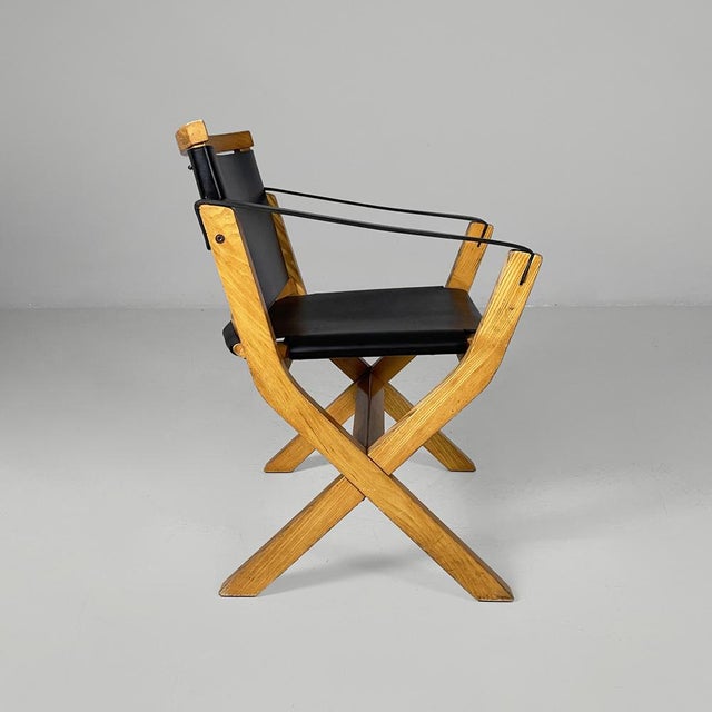 Italian postmodern armchair Kiu in wood and black leather for Luxoritalia, 2020s Armchair model Kiu in wood and leather....