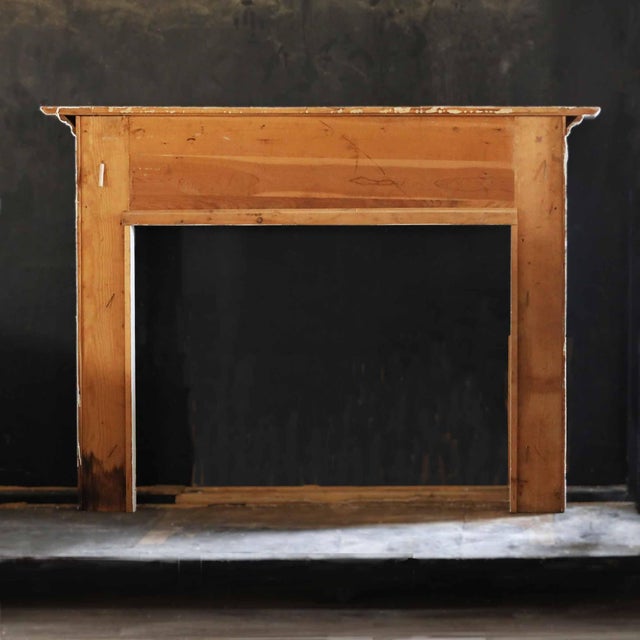 Vintage mid 20th century painted wooden mantel with decorative moulding. Off white paint. Opening dimensions:W:50" X H:37.5".