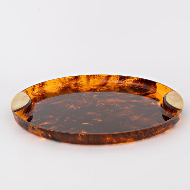 Beautiful mid century faux tortoiseshell tray with brass handles. This tray is designed by the Italian company Guzzini in...