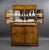 An exceptional Art Deco cocktail cabinet, crafted in burr walnut with a striking book-matched grain and gently rounded...