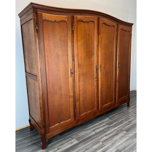 This elegant Vintage French Louis style wardrobe showcases refined proportions, beautifully panelled doors, and a softly...