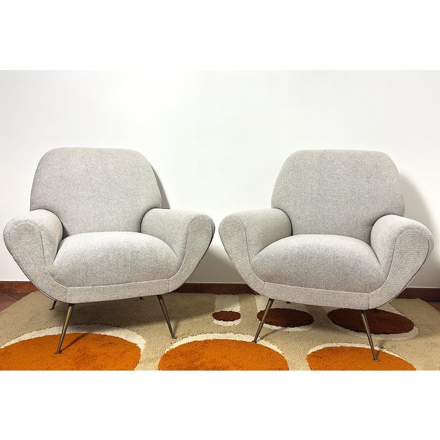 An extraordinary pair of 1950s armchairs by designer gigi radice, an icon of mid-century design. This pair perfectly...