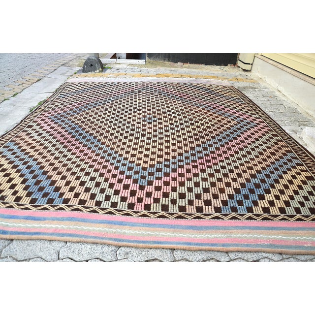 This is a vintage Turkish Anatolian kilim rug from the 1960s. The piece was hand-woven.