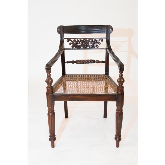 Each with back centered by foliate-carved open backsplat; with reeded downswept armrests resting on baluster-form...