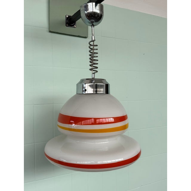 Vintage Space Age-style ceiling lamp, crafted from cased blown glass and chrome-plated steel. The lampshade features a...