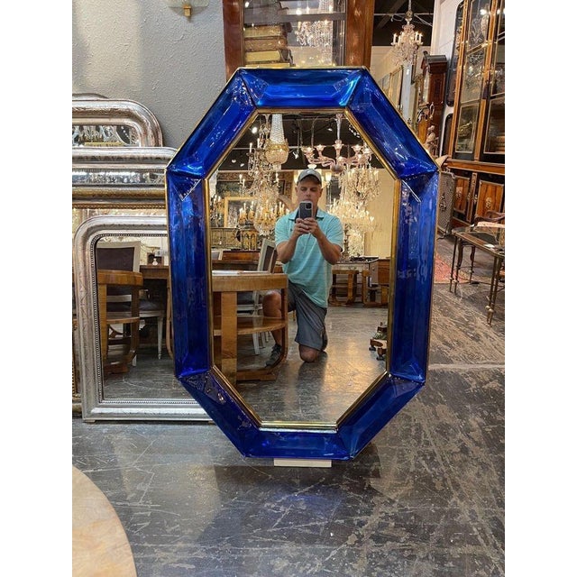 Impressive large scale blue Murano glass and brass mirror. Creates a beautiful decorative look!