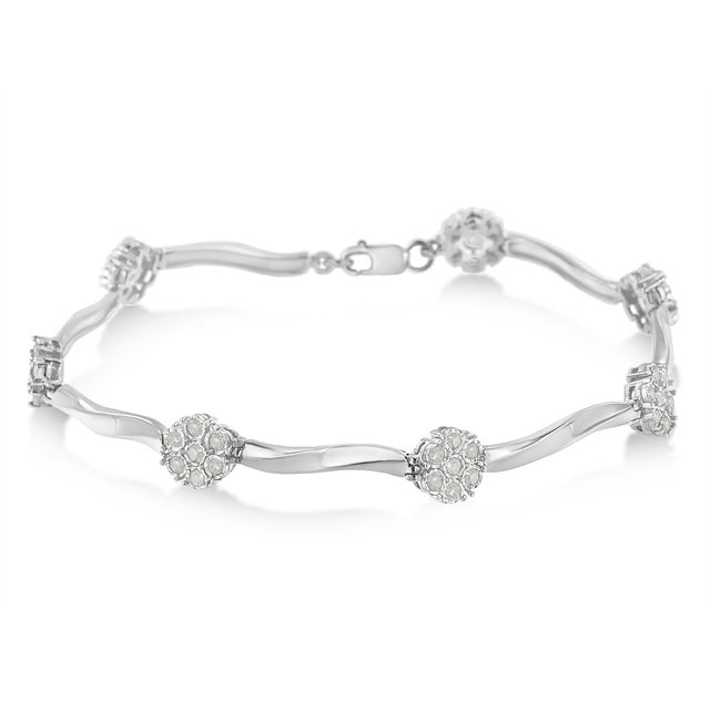 Elegant and scintillating, this sterling silver 1 ct diamond link bracelet features 7 miracle set floral clusters. Each...