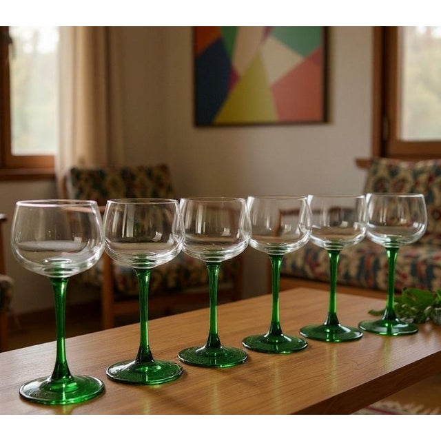 A vibrant set of 6 vintage Luminarc Durand France wine glasses, featuring the iconic emerald green stem that has become a...