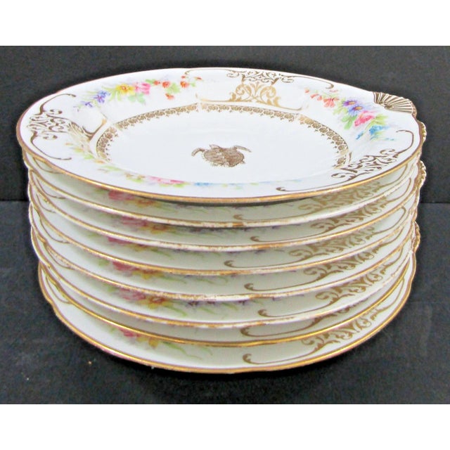 The Charles Ahrenfeldt Limoges France Gold Turtle and Shell Oyster Bowl Set of 8 is a stunning collectible set of round...