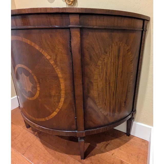 This charming English commode is adapted from a 1780 original. The top features mahogany and satinwood inlays within a...