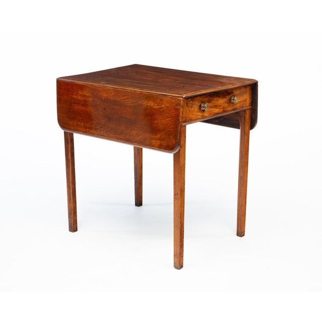 An elegant late Georgian English Pembroke table crafted in richly figured mahogany, dating to the late 18th or early 19th...