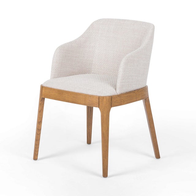Effortlessly transitional. Finished in a light honey, splayed parawood legs support a shapely upholstered seat of high-...