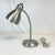 This is a perfect little desk lamp to illuminate your work space. It features a gooseneck, articulating stem with a metal...