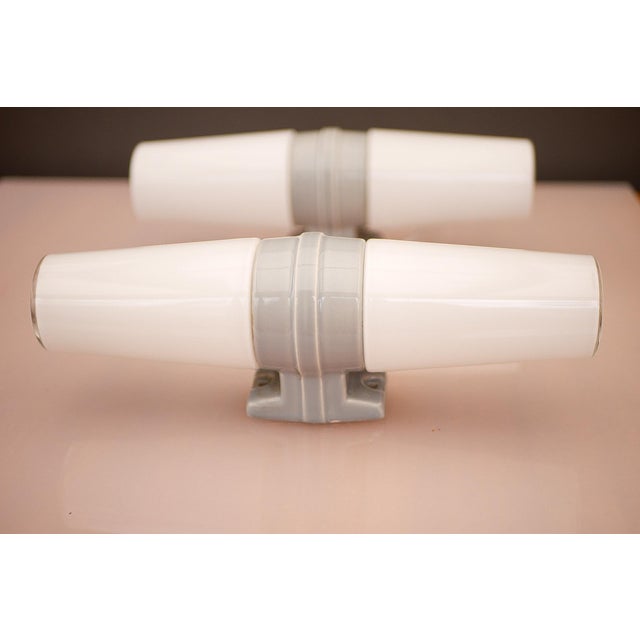 A rare pair and highly desirable mid-century modern double porcelain wall sconces for bathroom use, produced by ifö,...