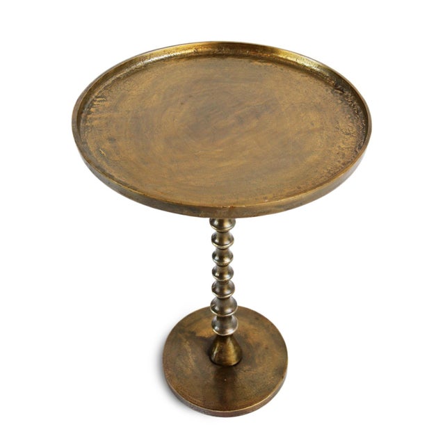 Retro modern style antiqued brass finish aluminum side table. Round top with scalloped pedestal base. Each will vary in...