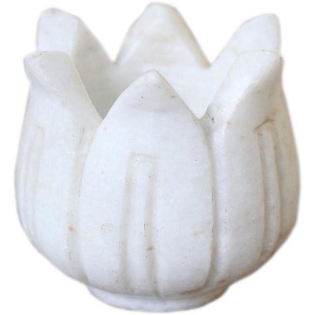 Add a touch of elegance to your space with this exquisite white marble lotus tea light holder. Expertly crafted in India...
