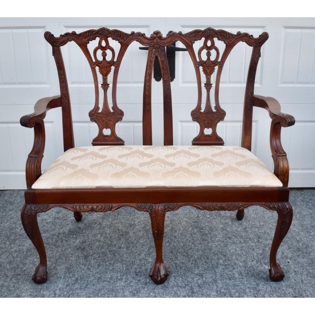 Vintage (1990's) Settee has a Chippendale Style. Made of Wood. Mahogany. Carved. Ball & Claw Feet. The Measurements: 44"W...