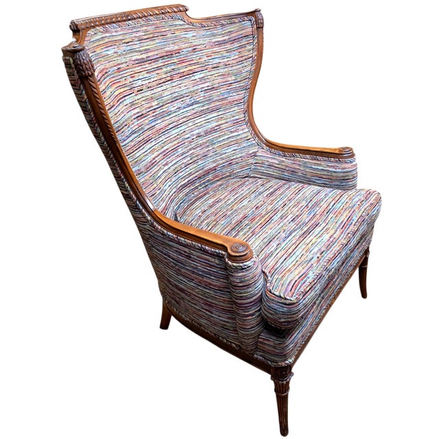 Louis XVI Revival carved walnut fauteuil armchair, dating to the 20th century, distinguished by its finely carved...
