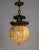 A sizable, crystal ball pendant light, topped with giant, cast bronze, curling acanthus leaves. It is composed of...