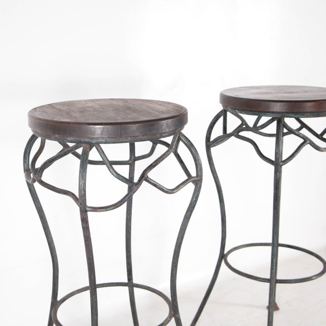 Beautiful pair of wrought iron and wood side tables, circa 1960. The wrought iron legs are shaped to resemble branches and...