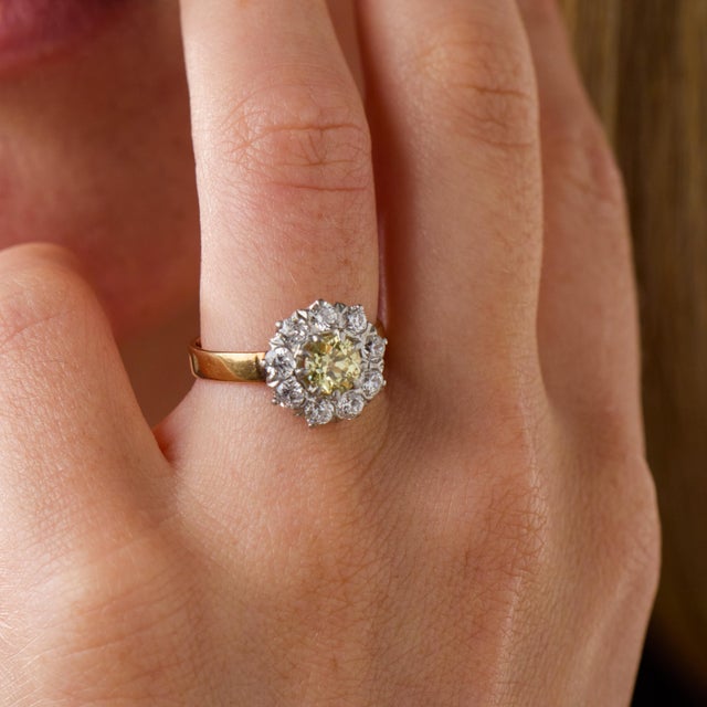 This striking Edwardian cluster ring is a beautifully distinctive jewel from the 1910’s, centered by an old European cut...