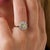 This striking Edwardian cluster ring is a beautifully distinctive jewel from the 1910’s, centered by an old European cut...